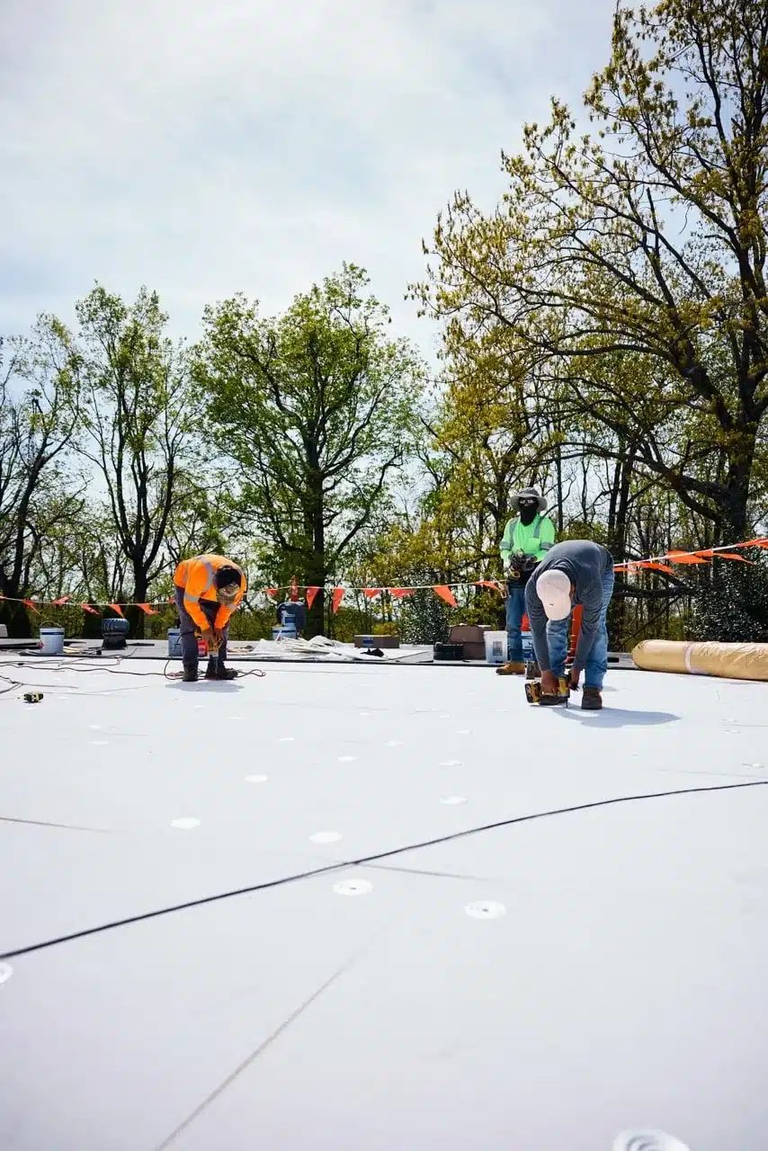 Commercial roofing St Louis crew installing membrane on a flat roof